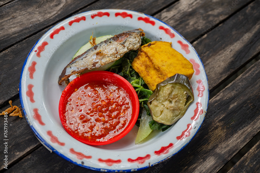 Traditional food of Javanese chicken, tofu, tempe and chili sauce. The ...