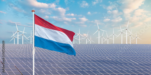 Official flag of The Netherlands in front of a large array of solar panels and wind turbines