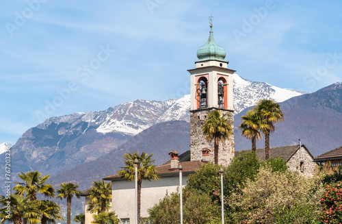 View of the bell tower of Church of Saints Peter and Paul (Santi Pietro e Paolo) in Vira Gambarogno, district of Locarno, Ticino, Switzerland. photo