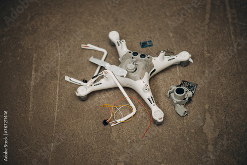 Fallen damaged quadcopter drone crash on a floor.