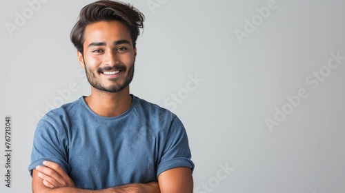 Portrait of a man of oriental appearance on a monochrome background. A Hindu man in a T-shirt.