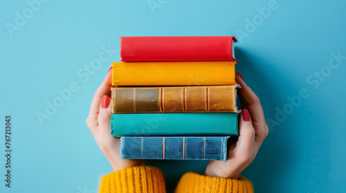 Woman Holding a Stack of Books