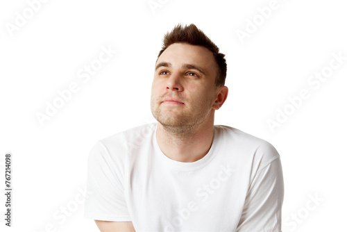 Young dreaming man with short brunette hair looking up dressed white t-shirt against white studio background. Concept of natural beauty, spa treatments, masculine, cosmetology.