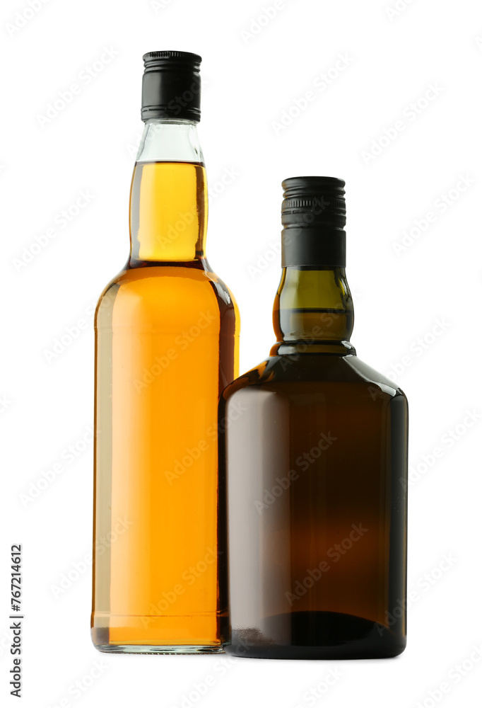 Different sorts of whiskey in glass bottles isolated on white Different sorts of whiskey in glass bottles isolated on white