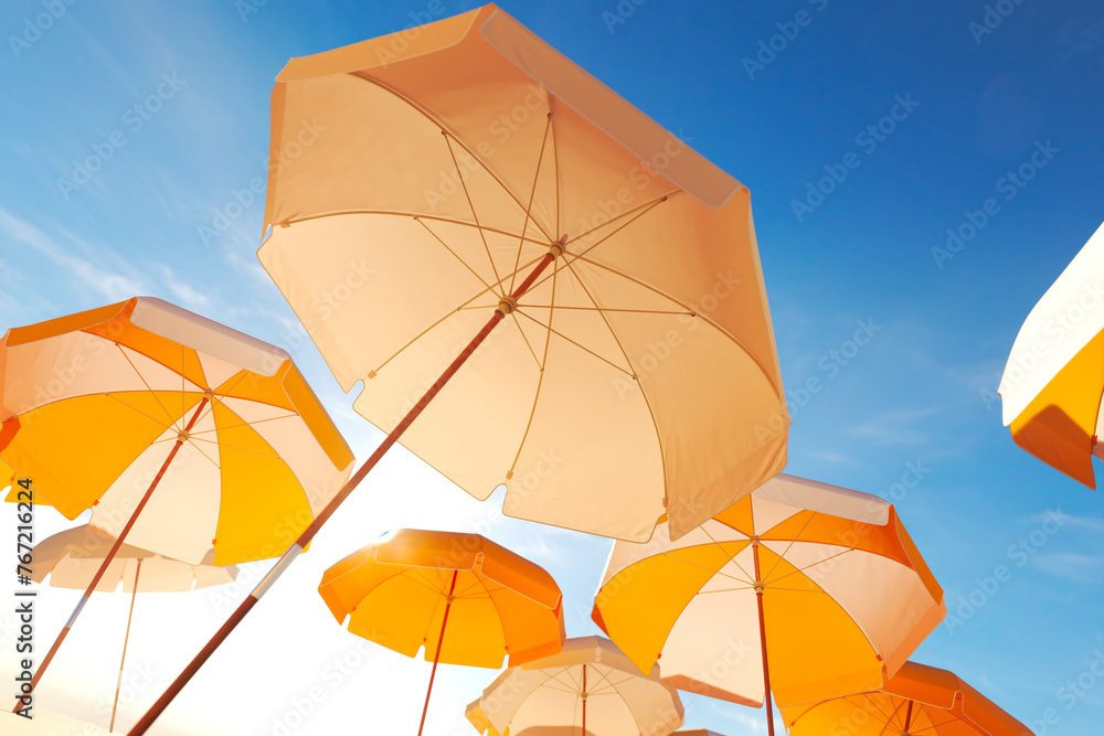 Vibrant Orange Beach Umbrellas Open Against a Clear Blue Sky on a Sunny Day