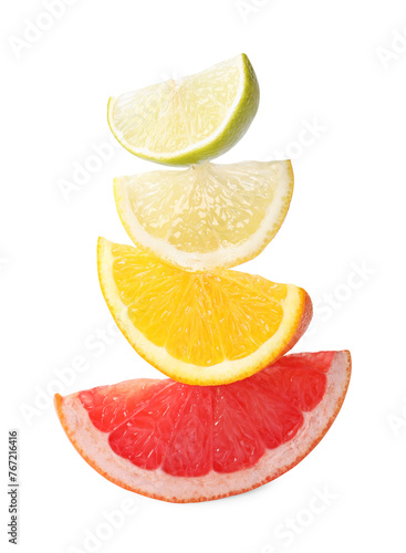 Cut fresh citrus fruits isolated on white