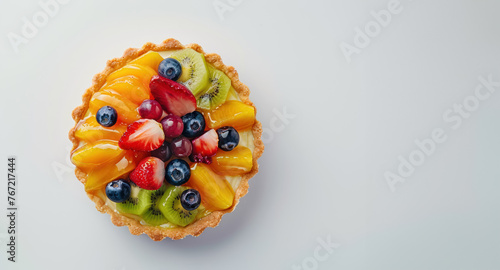  colorful glazed fruit tart on light background, free space for text 