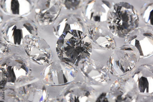 Many beautiful shiny diamonds on light background, closeup