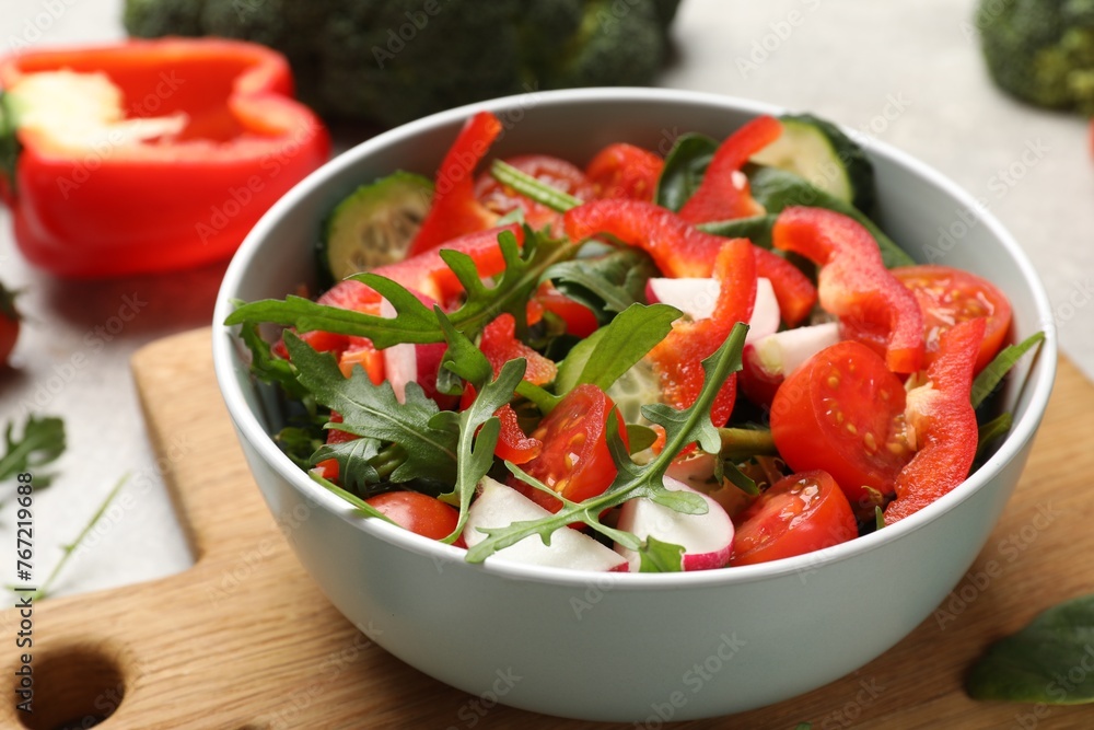 Tasty fresh vegetarian salad on light grey table, closeup Tasty fresh vegetarian salad on light grey table, closeup