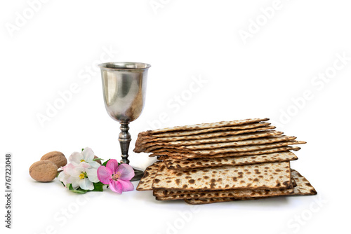Matzo, wine, pink flowers apple tree, nuts for passover celebration on a white background with space for text