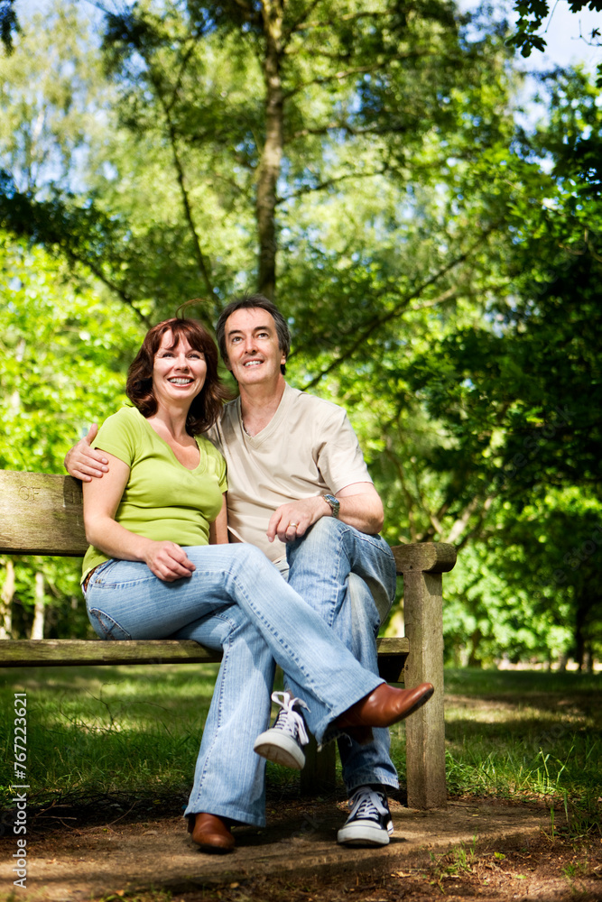 Life begins at 40. A candid and affectionate moment between a mature couple enjoying time together in a sunny woodland park. Life begins at 40. A candid and affectionate moment between a mature couple enjoying time together in a sunny woodland park.