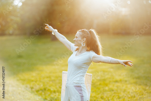 smiling elegant woman in white shirt in meadow outdoors