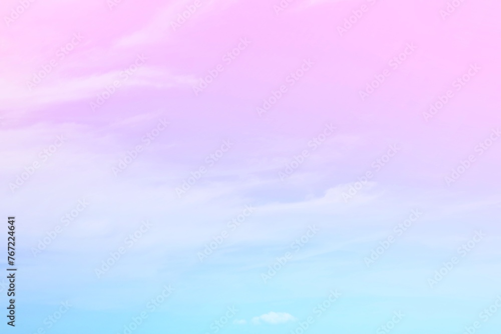The delicacy of the soft white clouds  On a background of a faded sky with gradients of pink, purple and pastel blue.  The combination is gentle and beautiful.