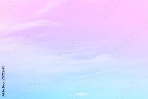 Fototapeta Naklejka Na Ścianę i Meble -  The delicacy of the soft white clouds  On a background of a faded sky with gradients of pink, purple and pastel blue.  The combination is gentle and beautiful.