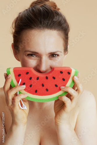 smiling young woman with watermelon shower sponge
