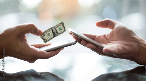 Two mobile phones touching each other. Money transferred through the application Refers to the convenience and speed of transferring money  photo