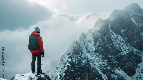 Young man wearing mountaineering clothing. Climbing a mountain. Snowy mountain scenery. cloudy white sky It represents challenge, courage, and greatness. 