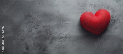 A red heart on a gray background