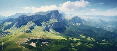 A sweeping vista of a mountain range and sparse green hills