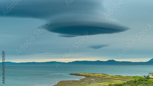 Timelapse of Lenticular clouds over sea with mountains on Beagle canal in Tierra del Fuego, Argentina and Chile. photo