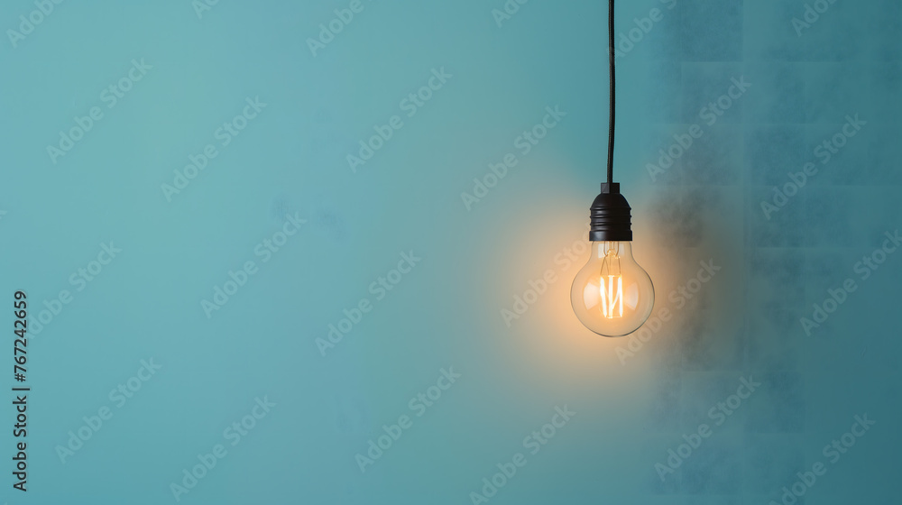 Minimalistic Light Bulb Hanging Against a Blue Background Minimalistic Light Bulb Hanging Against a Blue Background