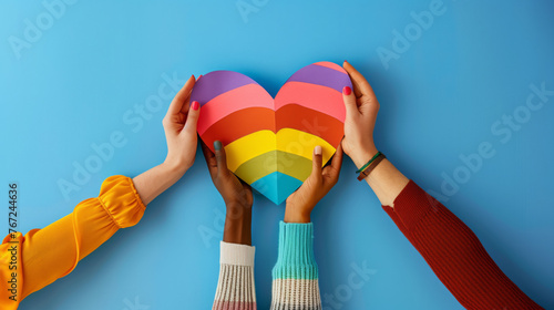 Diverse Group of Hands Holding Rainbow Heart