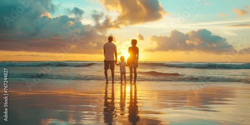 Family enjoying beach sunset with reflection