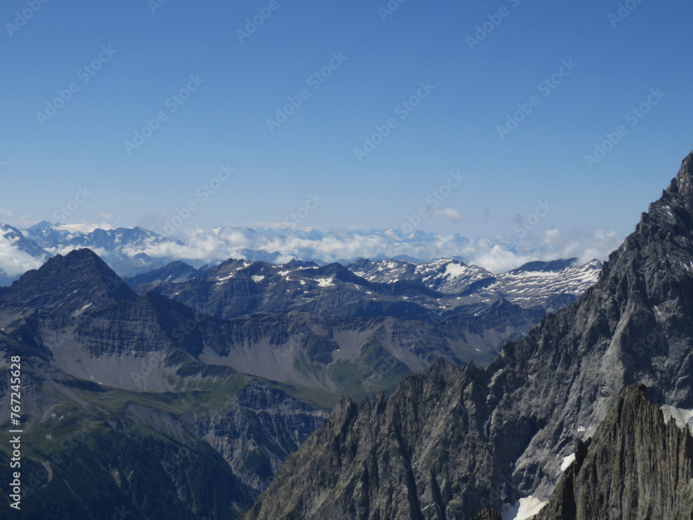 Landscape with view of the mountainsides of the Mont-Blanc during the summer from the Pointe Helbronner. Alps Chain Mountains. Border between Italy and France. Landscape with view of the mountainsides of the Mont-Blanc during the summer from the Pointe Helbronner. Alps Chain Mountains. Border between Italy and France.