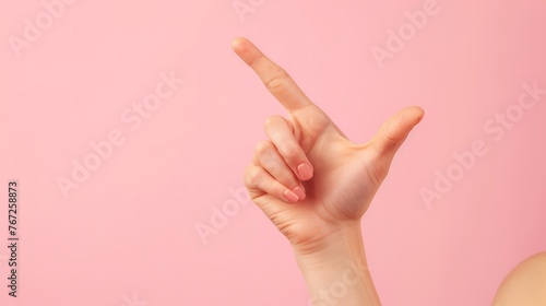 Hand showing ok sign with fingers isolated over pink background.  photo