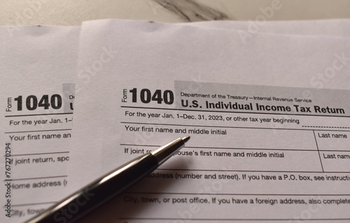 A closeup picture of a Form 1040 on a table with a black pen on it