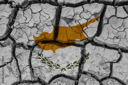 Obraz na płótnie Dry soil pattern on the flag of Cyprus. Country with drought concept due to climate change. Water problem. Dry cracked earth country. w salonie