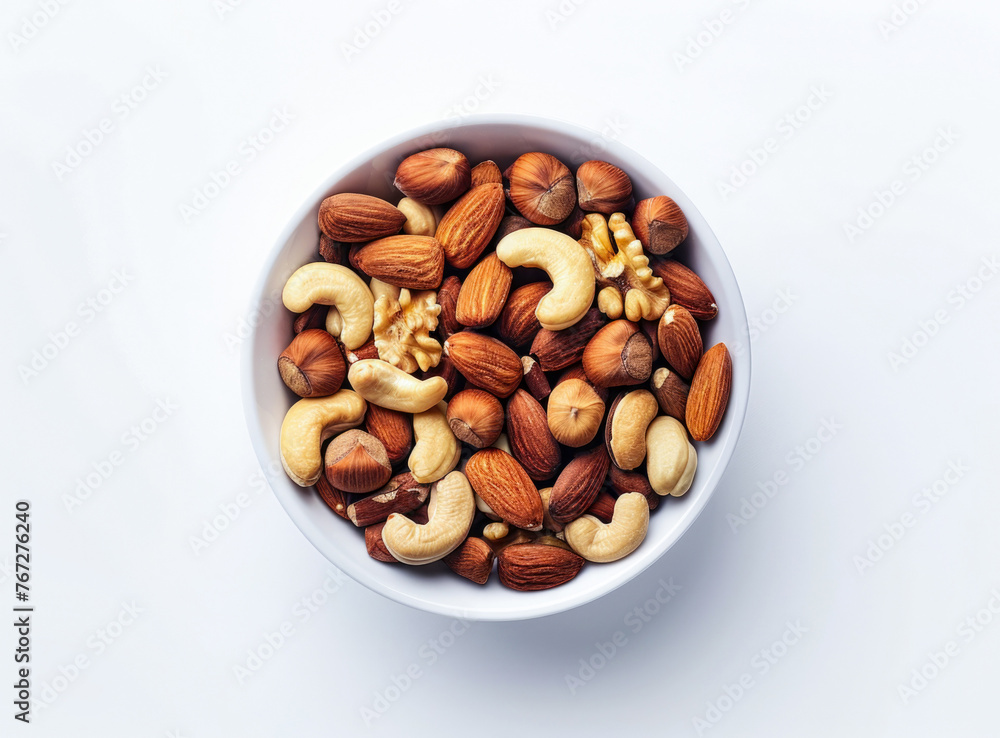An aerial perspective capturing a bowl filled with a variety of nuts on a white tabletop, highlighting the wholesome combination of walnuts, pistachios, almonds, hazelnuts, and cashews An aerial perspective capturing a bowl filled with a variety of nuts on a white tabletop, highlighting the wholesome combination of walnuts, pistachios, almonds, hazelnuts, and cashews