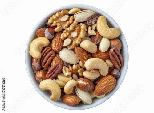 A top-down shot showcasing a bowl of mixed nuts arranged on a white table, offering a delightful assortment of walnuts, pistachios, almonds, hazelnuts, and cashews as a healthy snack choice