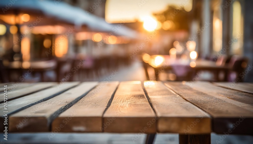 close up of an empty wooden table with a blurred background of a restaurant