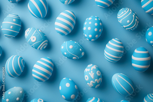 Pattern of blue and white Easter eggs over blue background 