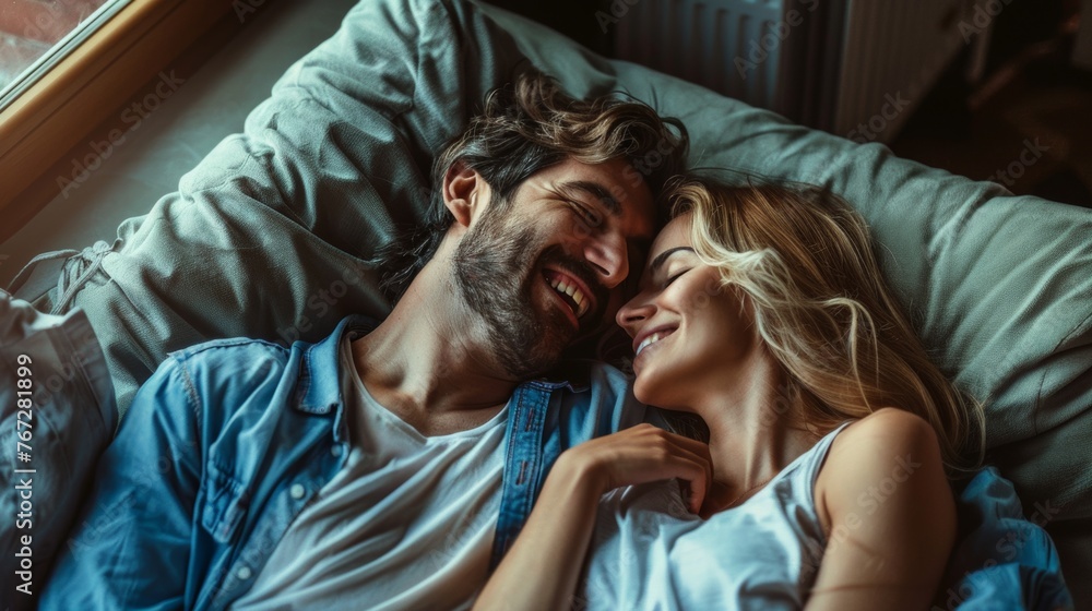 Happy couple sharing a loving moment in bed. Happy couple sharing a loving moment in bed.