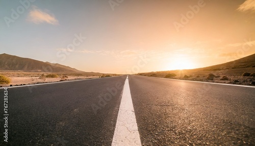 straight empty road background or wallpaper lead to nowhere central view low perspective fuerteventura spain