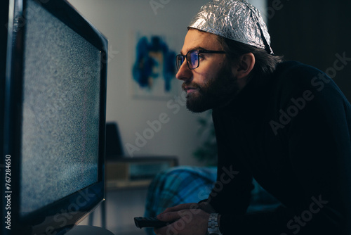 Man in Tin Foil Hat and Blanket Watching TV Interference