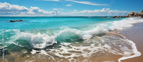 Bright seascape with surf waves crashing on sandy beach © KRIS
