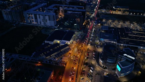 Wallpaper Mural Aerial high angle shot of evening roads in a city bustling with cars commuting. Drone flyover footage of cityscape and vehicles driving along a road and over a bridge in an urban neighbourhood.
 Torontodigital.ca