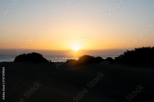 Sunrise over the sand dunes with sea