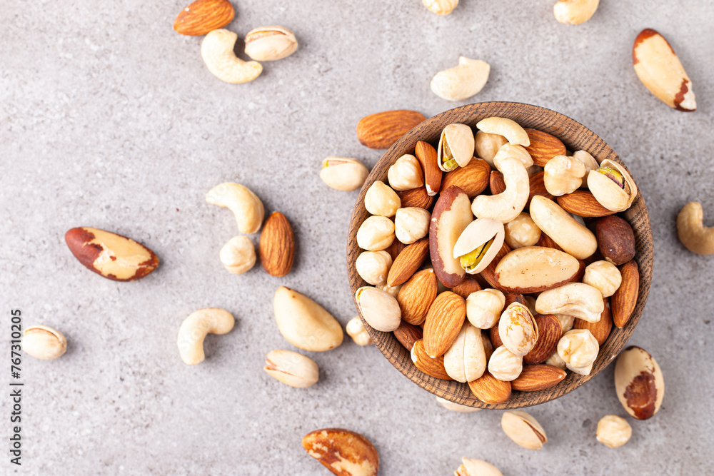 Healthy mix nuts on wooden background. Almonds, hazelnuts, cashews, peanuts, pistachios, Brazil nuts Healthy mix nuts on wooden background. Almonds, hazelnuts, cashews, peanuts, pistachios, Brazil nuts