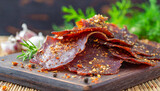 Close-up of smoked beef jerky with herbs. Tasty food. Delicious snack.