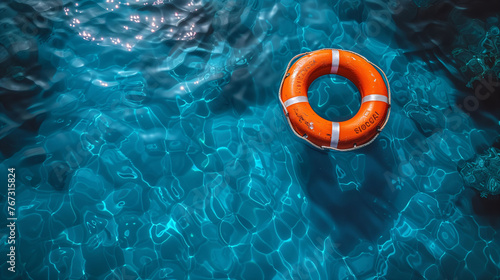 Orange lifebuoy floating on the rippling blue water of a swimming pool, symbolizing safety and rescue.