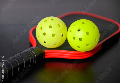 Pickleballs and paddle. The sport of pickleball has become very popular in the last several years.
