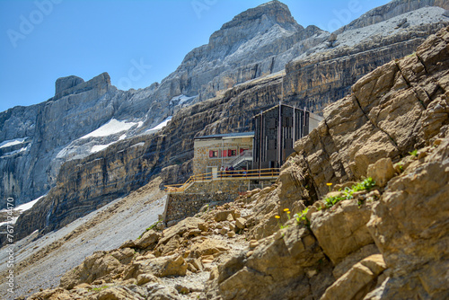 Refuge in the French Pyrenees, mountain view with the rocks, building, snow and the peak
