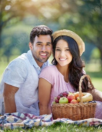 Happy couple, portrait and smile at park picnic or fruit basket for holiday snack for relationship, travel or relax. Man, woman and face in nature together