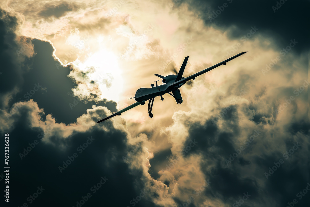 Fototapeta premium An abstract image of a combat drone silhouetted against a dramatic cloud-filled sky.