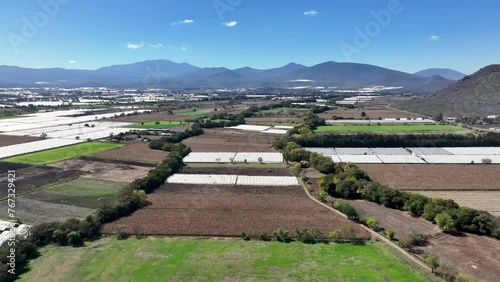 Drone shot of the cultivated fields and greenhouses on a sunny day in Gomez Farias city, Mexico photo