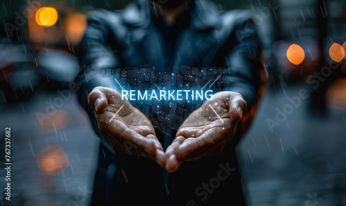 Businessperson Holding Digital Hologram of Remarketing Text Over Blurred Background, Representing Modern Rebranding, Marketing Strategies, and Digital Transformation in Business World